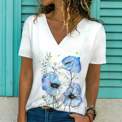 Person wearing a white t-shirt with blue floral design against a turquoise background
