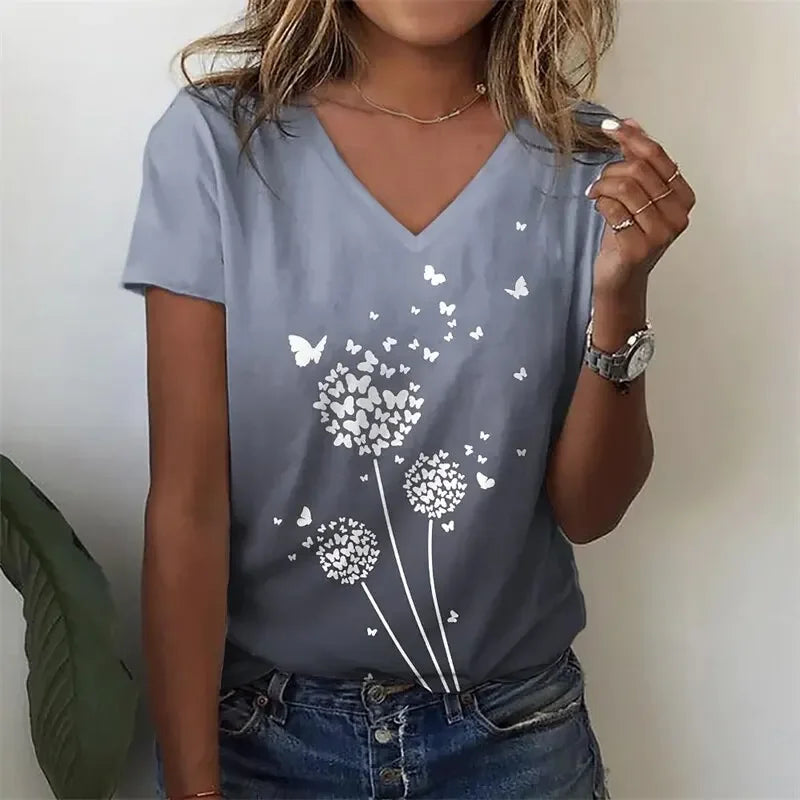 Person wearing a blue t-shirt with dandelion and butterfly design.