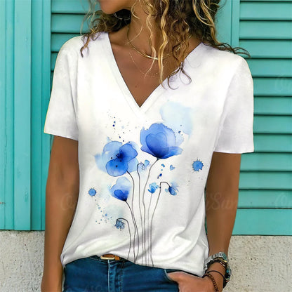 Person wearing a white t-shirt with blue floral design against a turquoise background