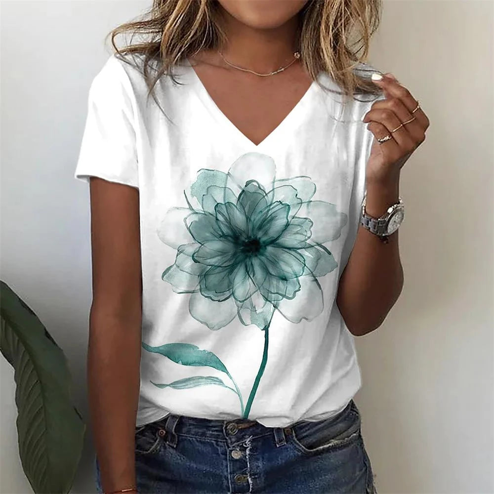 Person wearing a white t-shirt with a teal flower design.
