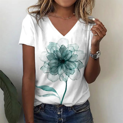 Person wearing a white t-shirt with a teal flower design.
