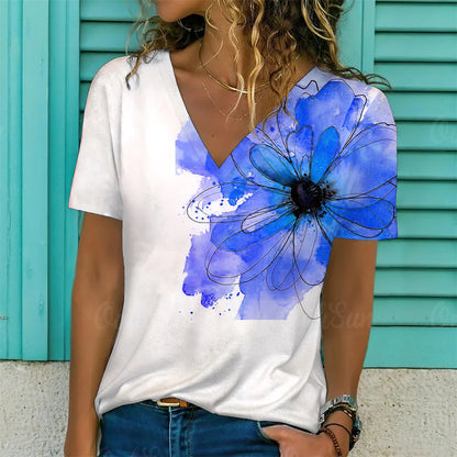 Person wearing a white t-shirt with a blue floral design against a turquoise background