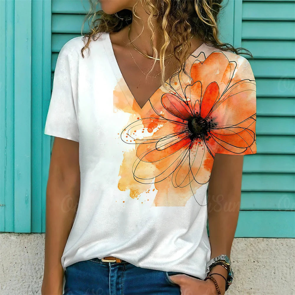 Person wearing a white t-shirt with a colorful flower design against a turquoise background