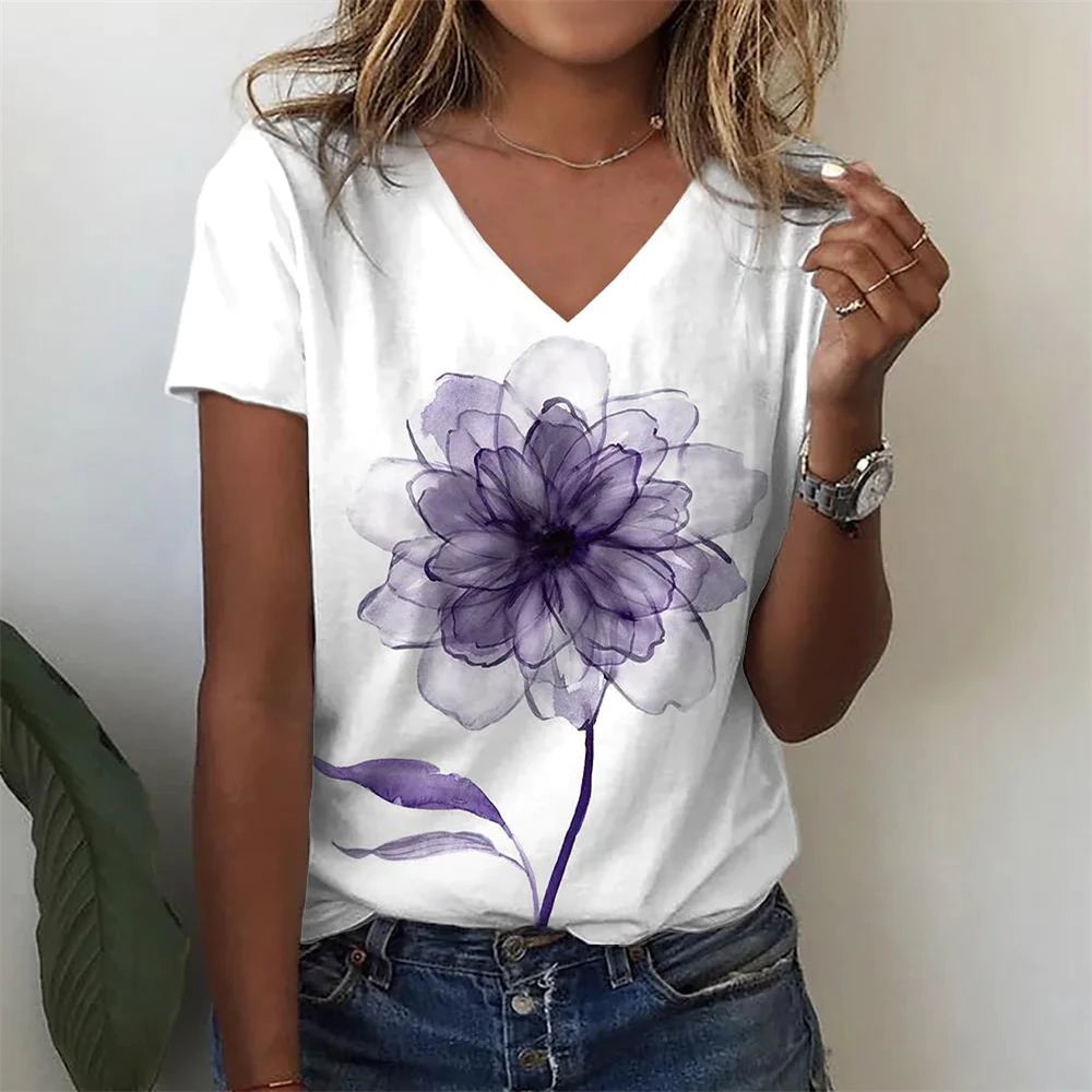 Person wearing a white t-shirt with a purple flower design.