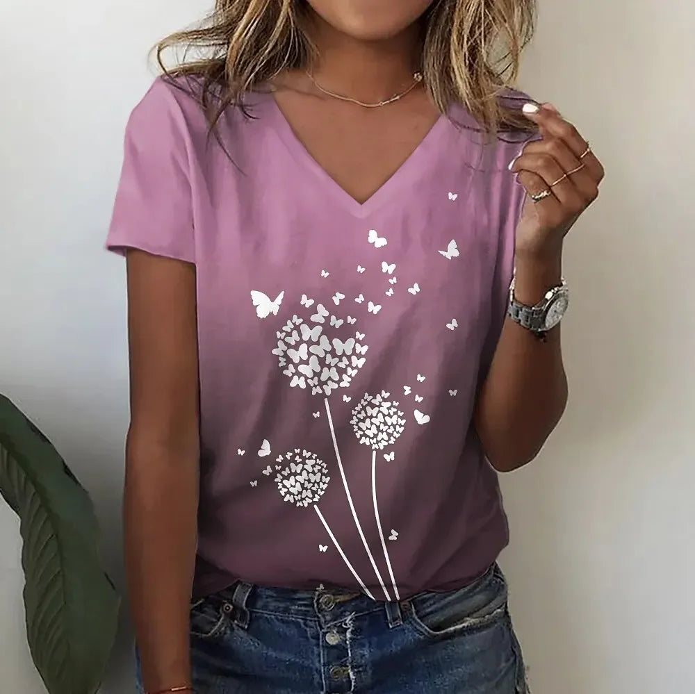 Person wearing a purple t-shirt with white floral designs against a plain background