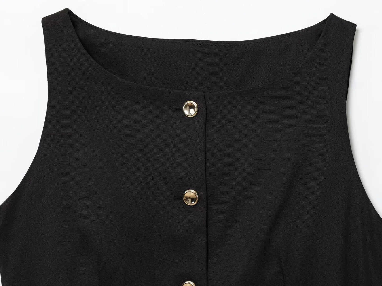 Black sleeveless top with gold buttons on a white background
