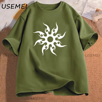 Green t-shirt with a white tribal sun design on a textured surface