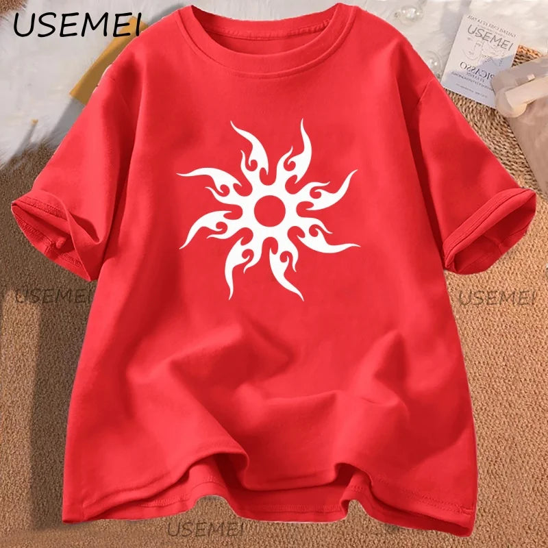 Red t-shirt with a white sun design on a textured surface