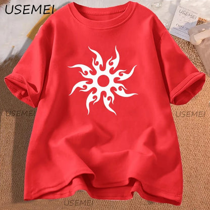 Red t-shirt with a white sun design on a textured surface