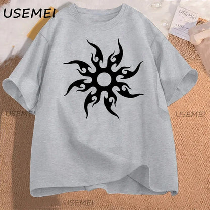 Gray t-shirt with black tribal sun design on a textured surface