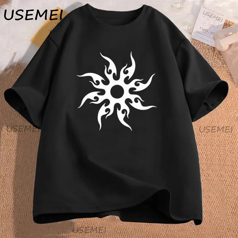 Black t-shirt with white sun design on a textured surface