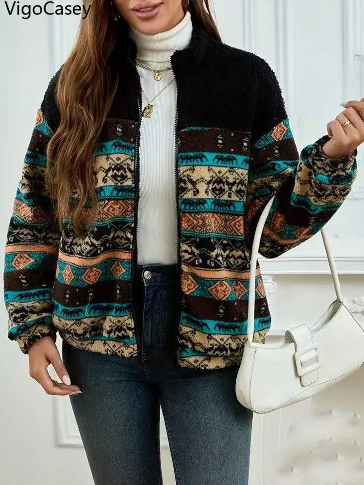 Woman wearing a patterned jacket with a white background, featuring the brand 'VigoCasey'.