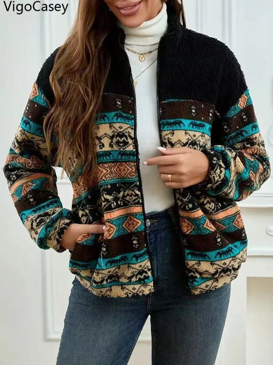 Woman wearing a patterned jacket with a white turtleneck and jeans indoors.