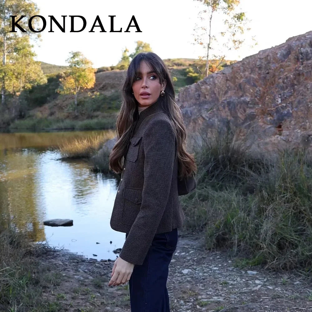 Woman standing by a lake with 'KONDALA' branding above her.