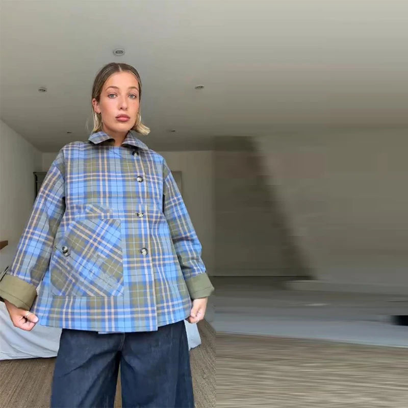 Person wearing a blue plaid coat in an indoor setting