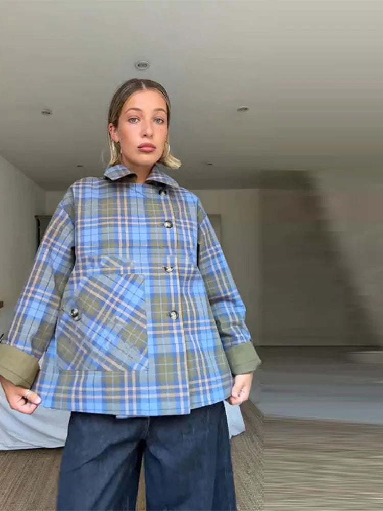 Person wearing a blue plaid jacket indoors