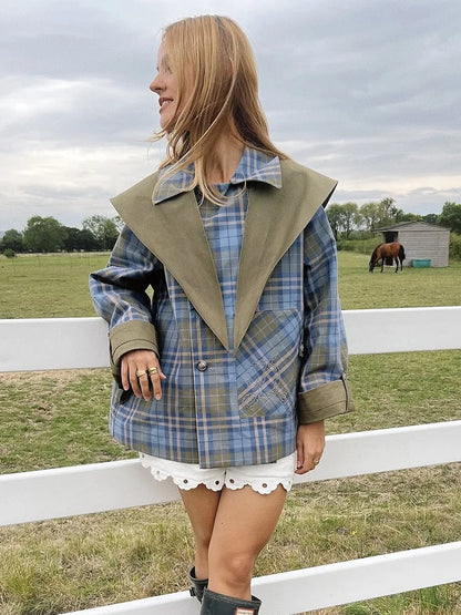 Woman wearing a plaid jacket with a horse and field in the background