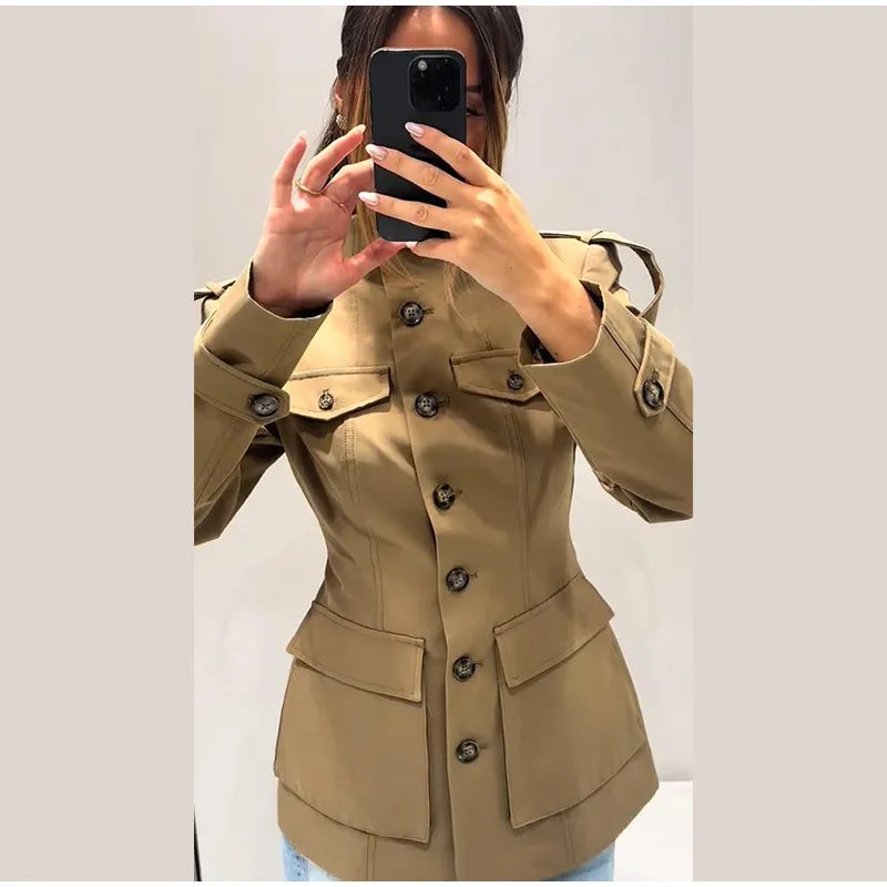 Beige trench coat worn by a person against a plain background