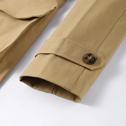 Close-up of a beige jacket with a button on a white background