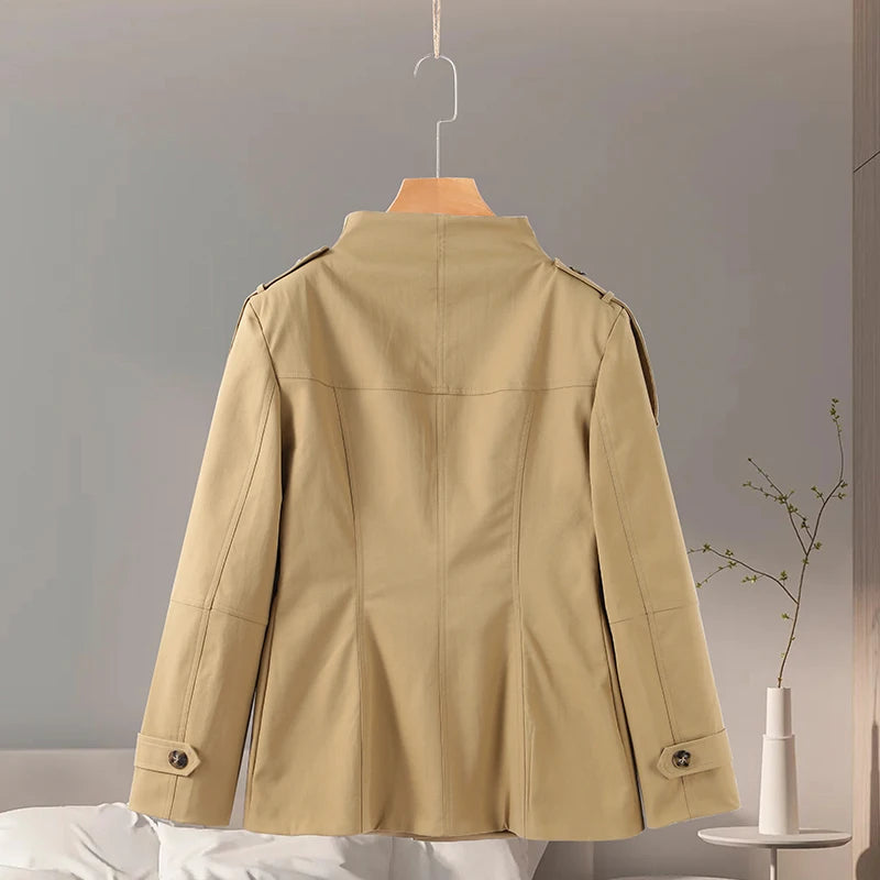Beige jacket on a hanger against a neutral background