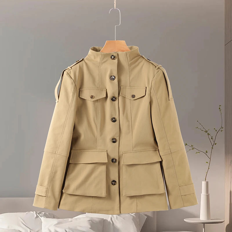 Beige jacket on a hanger against a neutral background