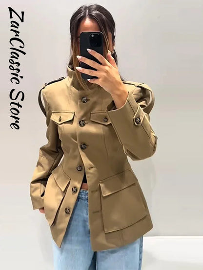 Person wearing a beige trench coat with a blurred background