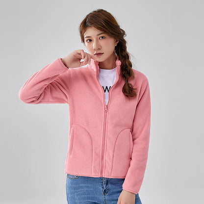 Woman wearing a pink jacket on a gray background