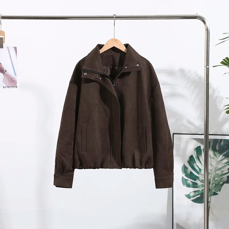 Brown jacket hanging on a rack against a white background