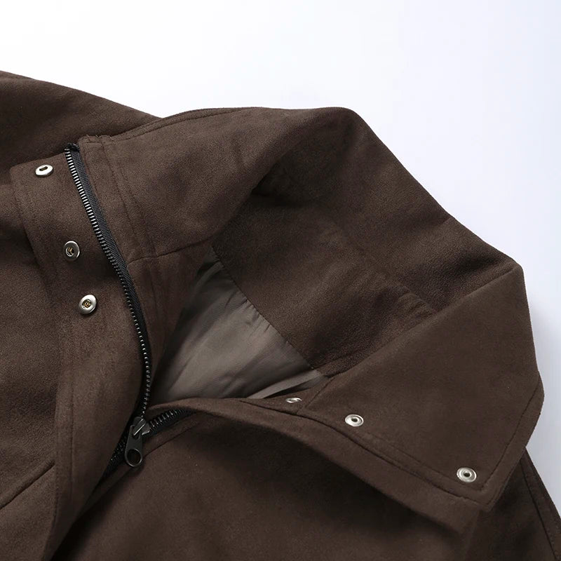Close-up of a brown jacket with a zipper and button details on a white background