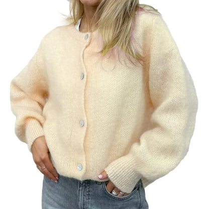 Cream-colored cardigan worn by a person on a white background