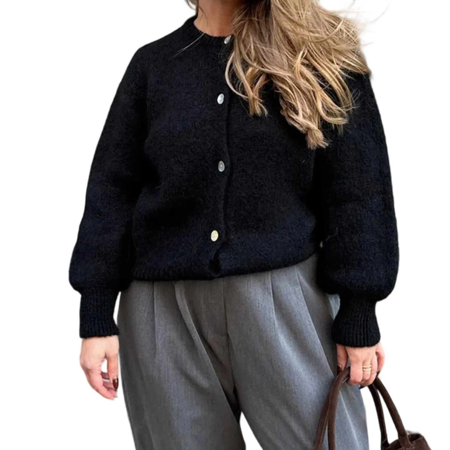 Person wearing a black cardigan and gray pants on a white background