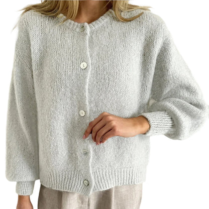 Light gray knitted cardigan worn by a person on a white background