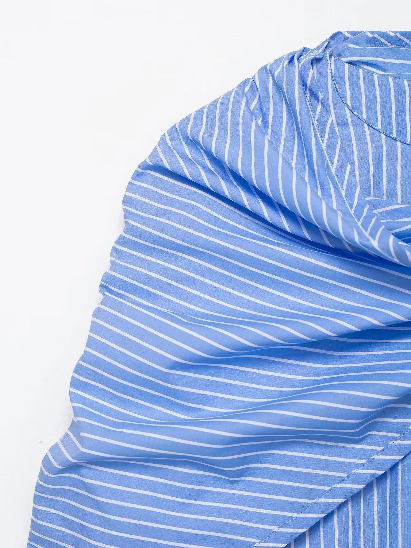 Close-up of a blue and white striped fabric with a white background