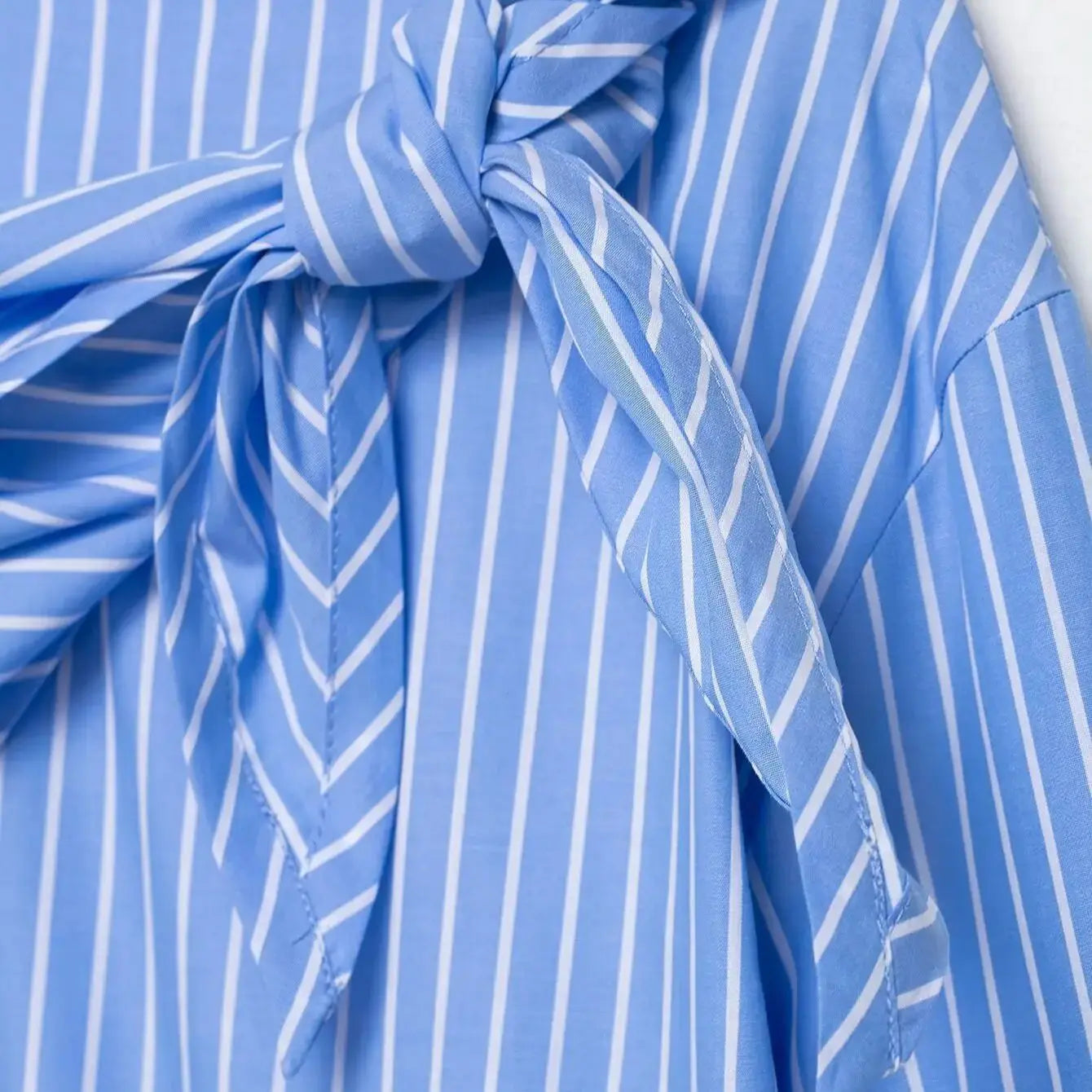 Close-up of a blue and white striped fabric with a knot.