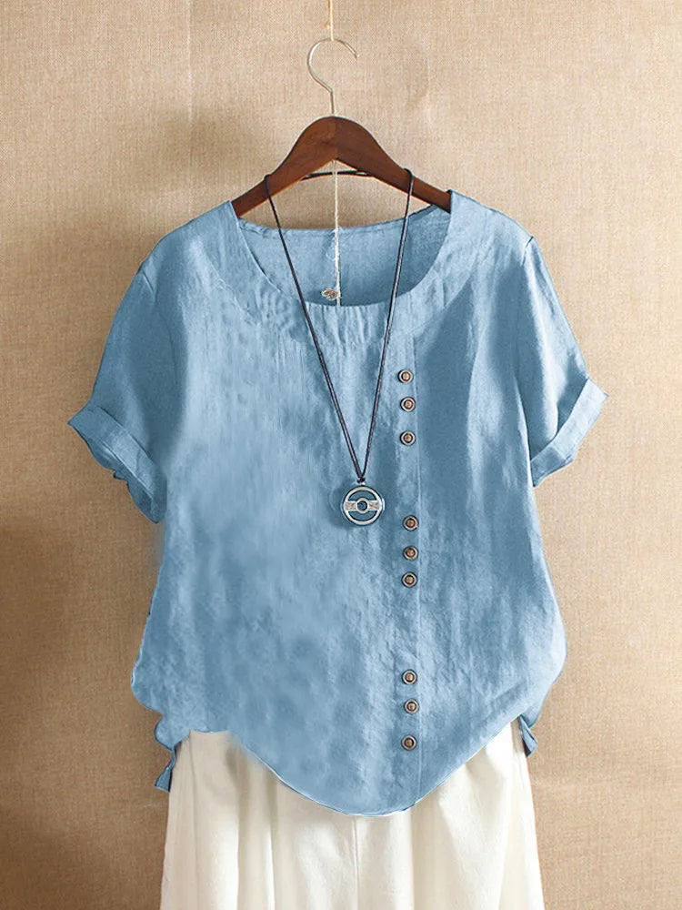 Light blue shirt with buttons on a hanger against a beige background