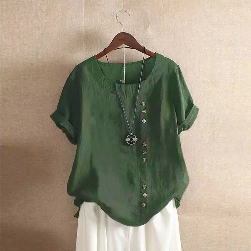 Green blouse with buttons on a hanger against a beige wall