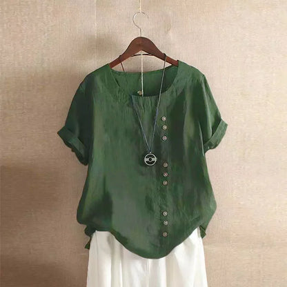 Green blouse with buttons on a hanger against a beige wall