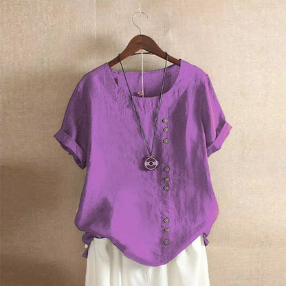 Purple shirt with buttons on a hanger against a beige wall