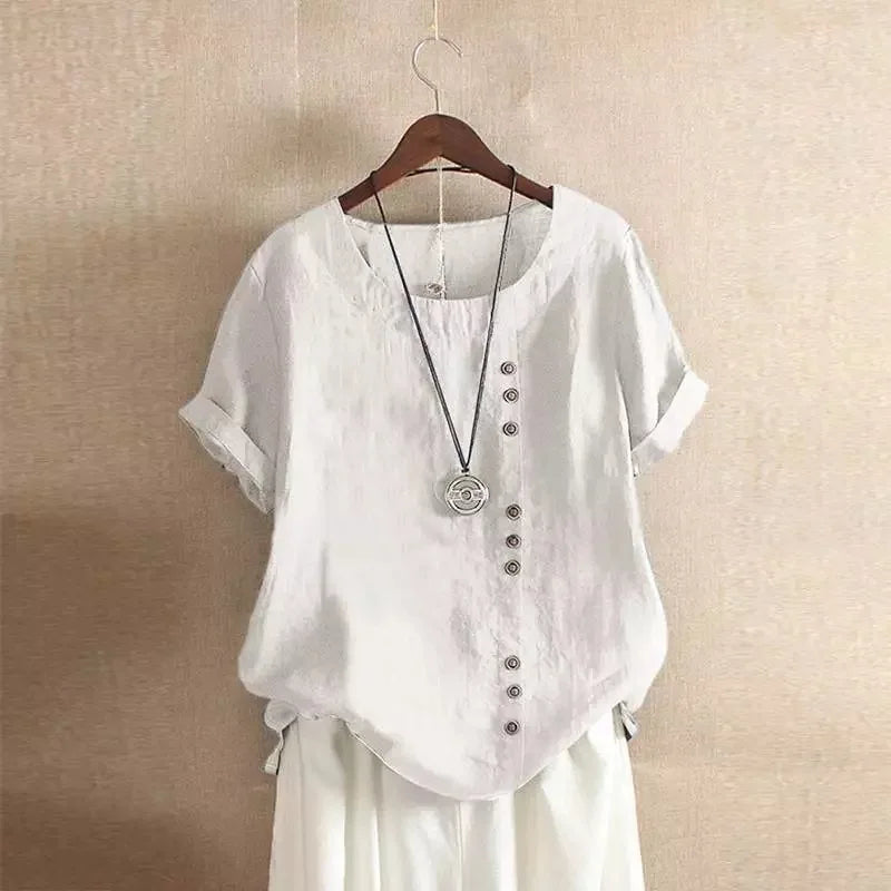 White shirt with buttons on a hanger against a beige wall