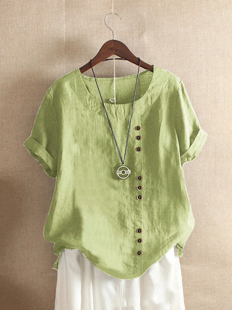 Green shirt with buttons on a hanger against a beige background