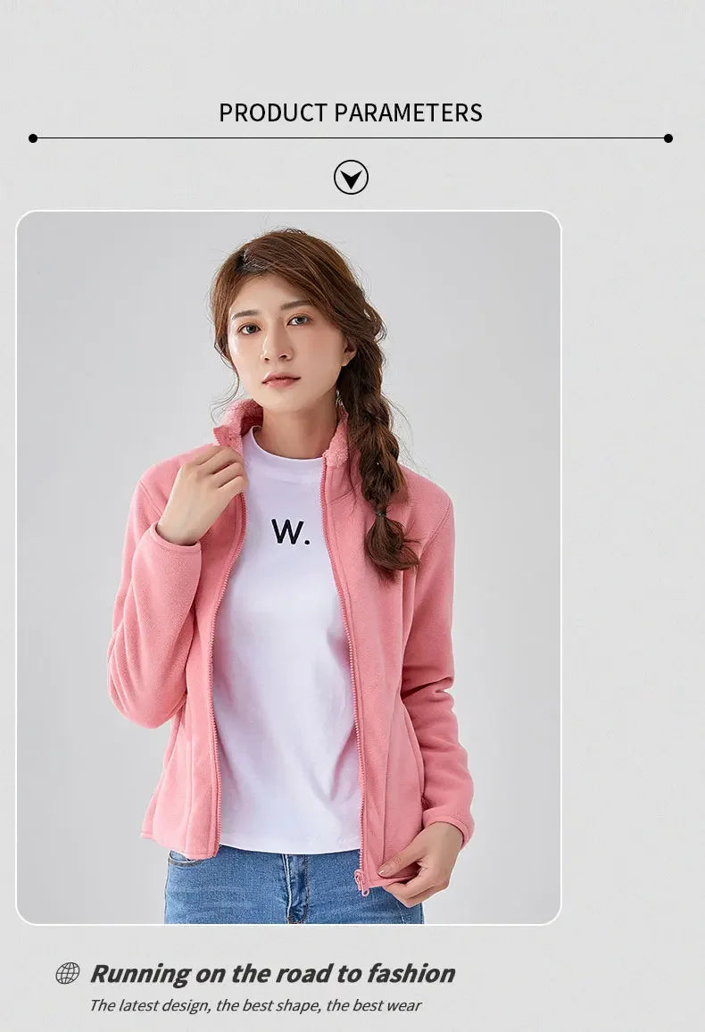 Woman wearing a pink jacket over a white shirt with 'W.' logo on a gray background