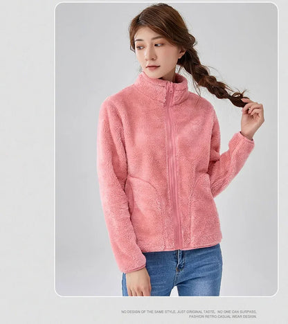 Person wearing a pink fleece jacket on a gray background