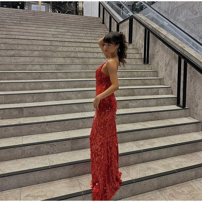 Woman in a red dress standing on a set of stairs
