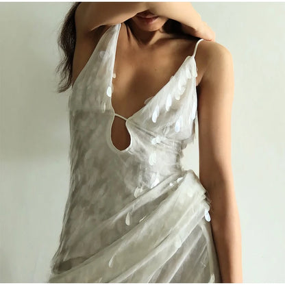 White lace dress with cut-out design on a plain background