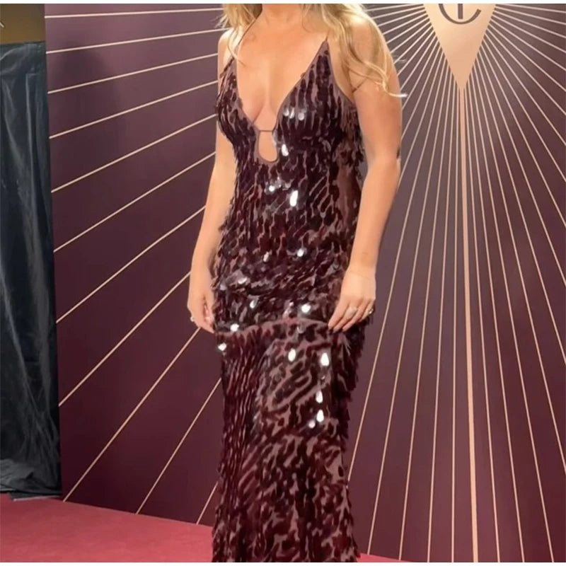 Person wearing a leopard print dress with sequins against a striped background