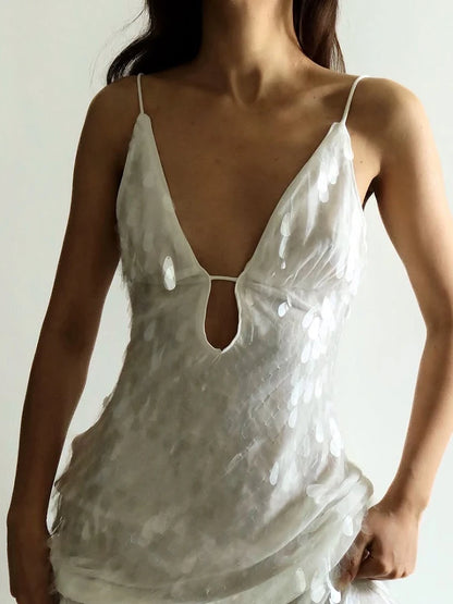 White lace nightgown worn by a person against a neutral background