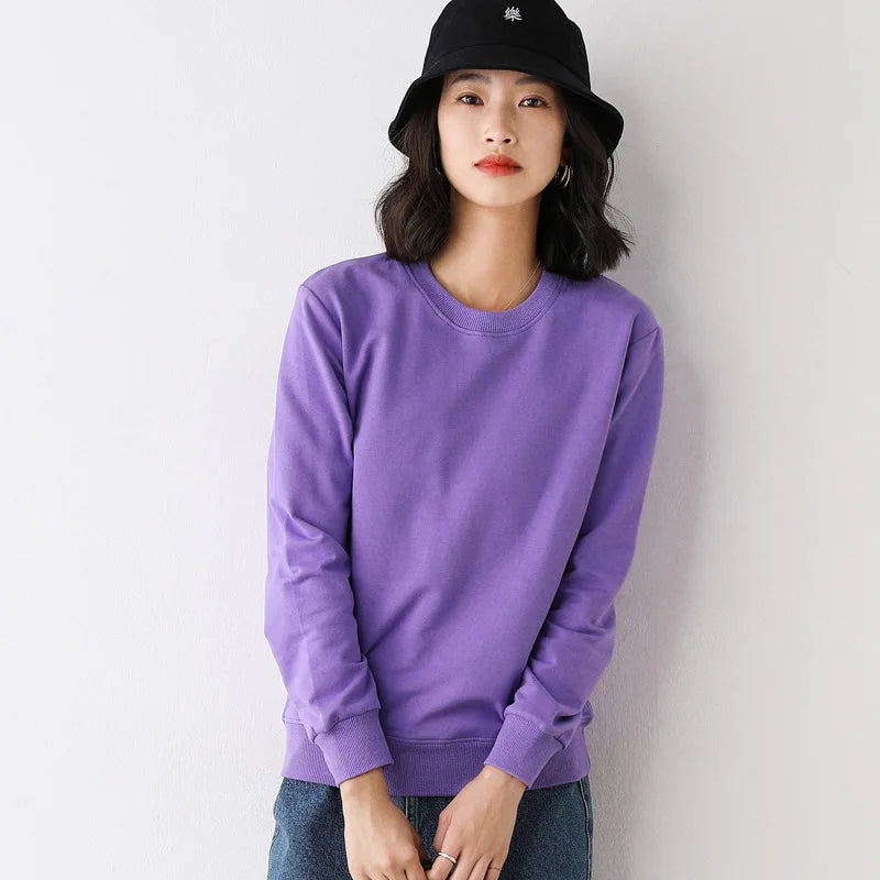 Person wearing a purple sweatshirt and black hat against a white background