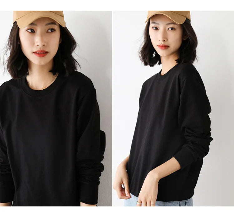 Woman wearing a black long-sleeve shirt and beige cap on a plain background