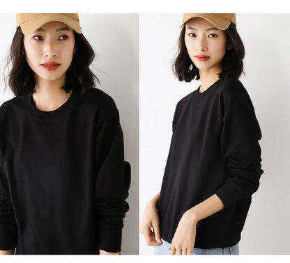 Woman wearing a black long-sleeve shirt and beige cap on a plain background