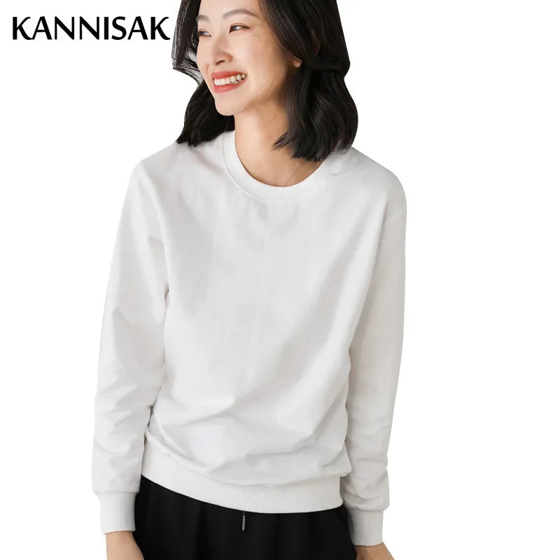 Woman wearing a white sweatshirt with 'KANNISAK' branding on a white background
